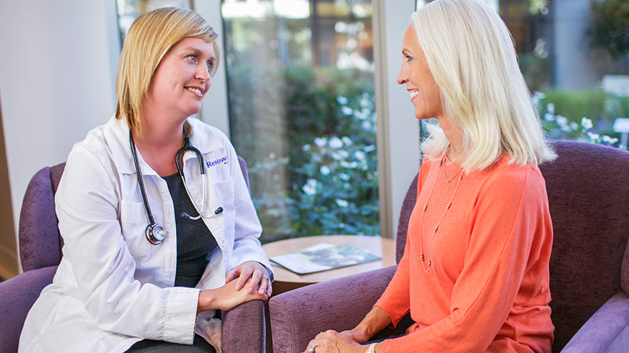 Nurse navigator consulting with cancer patient